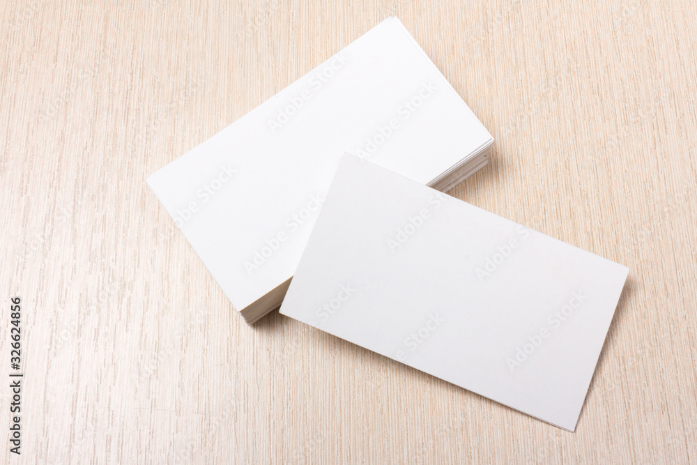 stacks of white blank business cards on a wooden surface stacks of white blank business cards on a wooden surface