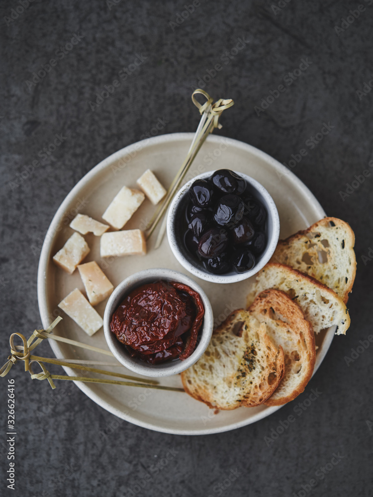 Snack to wine with dried tomatoes, olives and cheese Snack to wine with dried tomatoes, olives and cheese