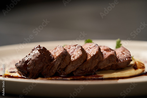 Filet mignon with mashed potatoes and pomegranate sauce, close-up