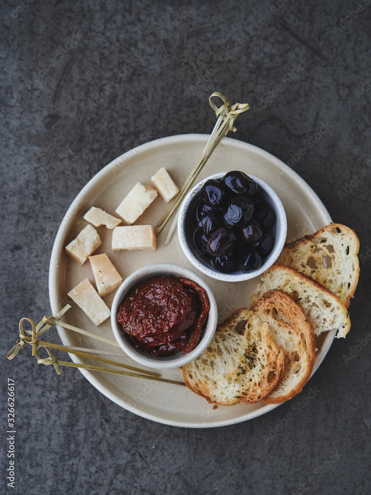 Snack to wine with dried tomatoes, olives and cheese Snack to wine with dried tomatoes, olives and cheese