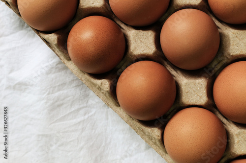 Fresh organic eggs in boxes and white cloth backgrounds