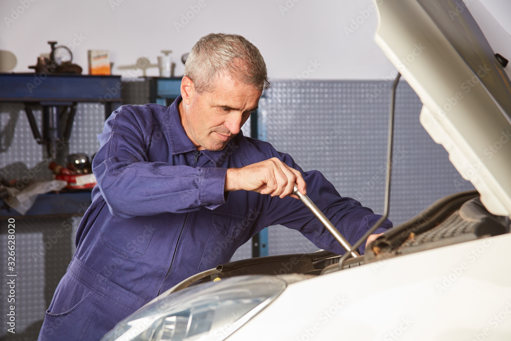 Mechatronics engineer at the repair of the car engine Stock Photo Adobe Stock