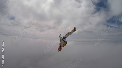Care. Skydiver does not survive in the air. Person controls his body. Extreme as a hobby.  © Viktor