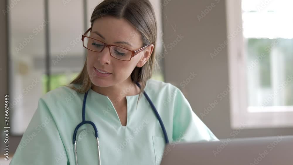 Portrait of nurse working on laptop computer Portrait of nurse working on laptop computer