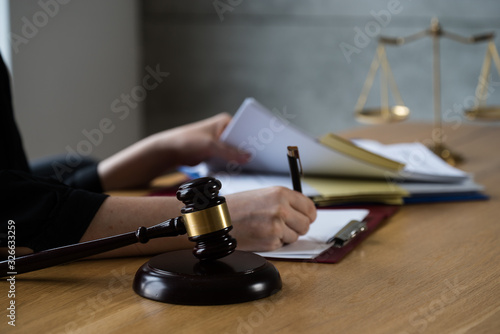 female lawyer working at the law firms. Judge gavel with scales of justice. Legal law, lawyer, advice and justice concept.