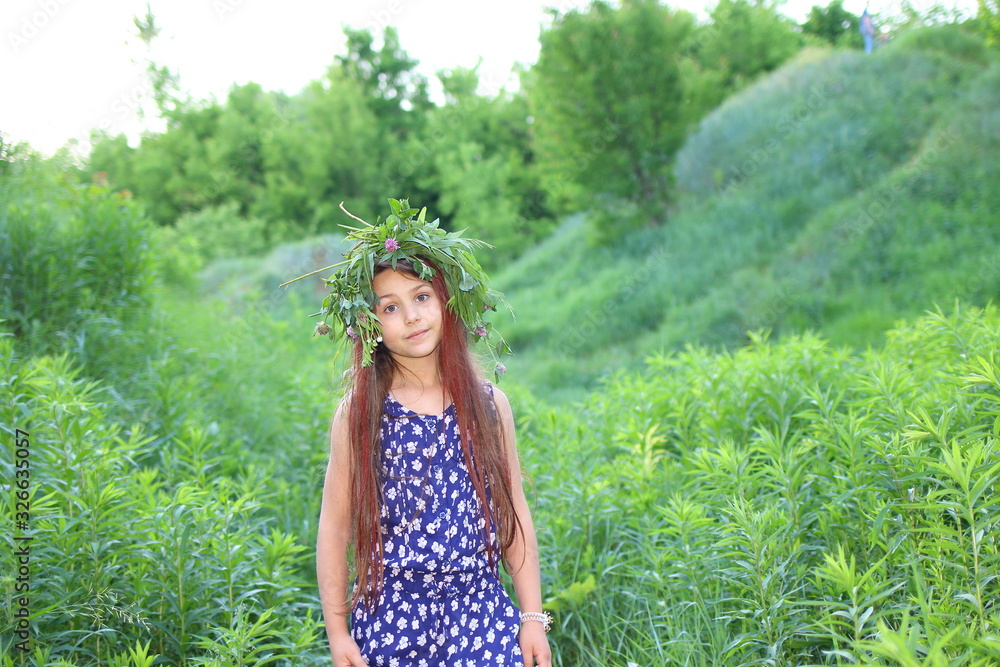 Cute Caucasian girl in a blue romper walks on a green lawn in a park. The concept of summer and relaxation. Vacations and leisure for children. Nature and flowers.
Cute Caucasian girl in a blue romper walks on a green lawn in a park. The concept of summer and relaxation. Vacations and leisure for children. Nature and flowers.