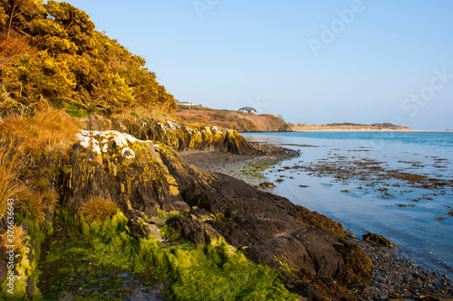 Low tide in a shingle cove at Inchydoney Island photo