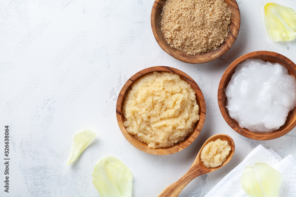 Sugar body scrub with ingredients on white stone table. Homemade cosmetic for spa. Sugar body scrub with ingredients on white stone table. Homemade cosmetic for spa.