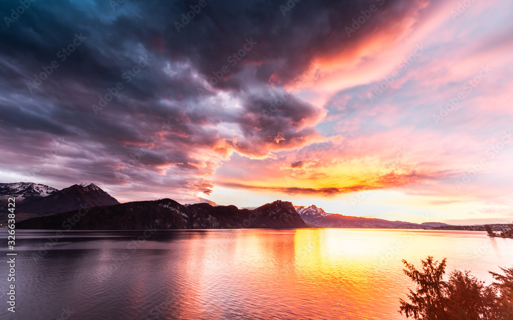 Bright dramatic sunset over the mountains and the lake. Switzerland. Lucerne.