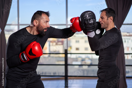 Boxer training with coach © Xalanx