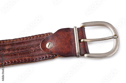 old, used brown leather belt on a white background