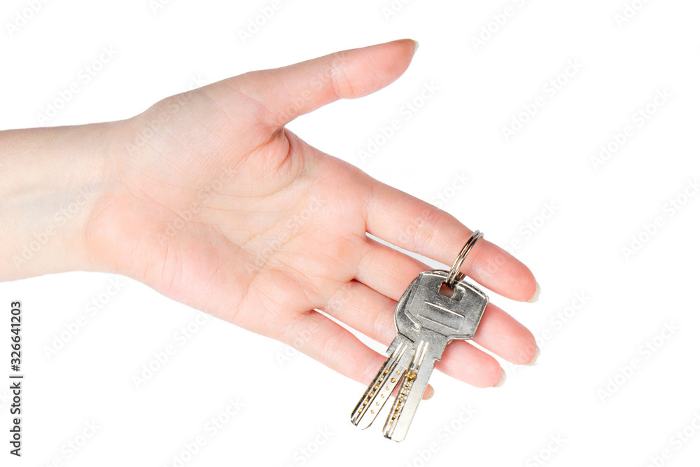 House keys in the female hand on a white background