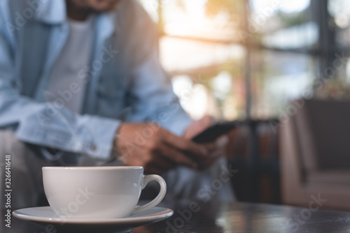 Man using mobile phone and coffee