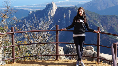 Young woman on the top of Ulsanbawi mountain in a Seoraksan National Park in South Korea, Asia.