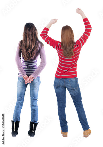 Back view of two woman in sweater.