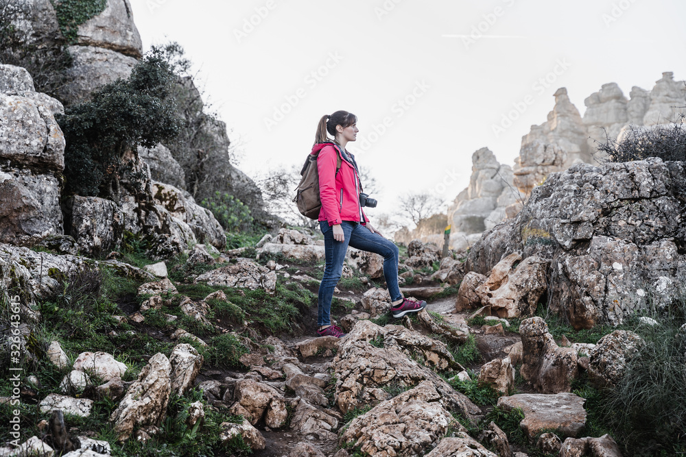 Young woman explorer photographing in the mountain. Concept of adventure, excursion and trips. Young woman explorer photographing in the mountain. Concept of adventure, excursion and trips.