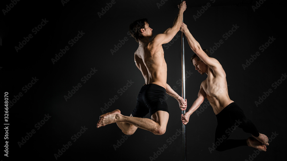 Portrait of young male doing a pole dance Portrait of young male doing a pole dance