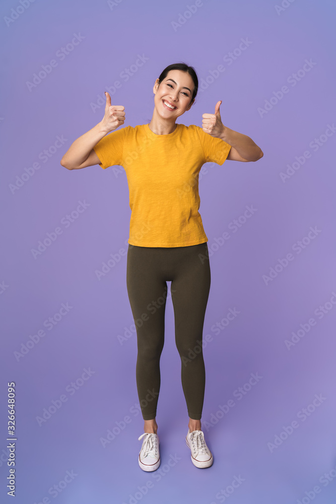 Cheerful young pretty sportswoman standing Cheerful young pretty sportswoman standing