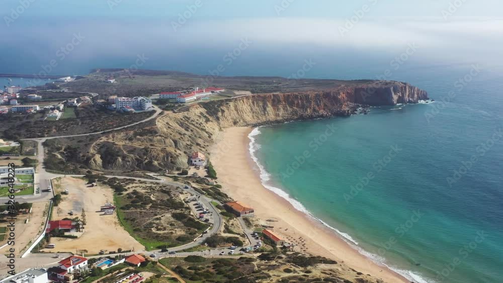 End of the European continent and fortress at Cape Sagres Portugal with Tonel town and beach lower right, Aerial drone approach reveal shot End of the European continent and fortress at Cape Sagres Portugal with Tonel town and beach lower right, Aerial drone approach reveal shot