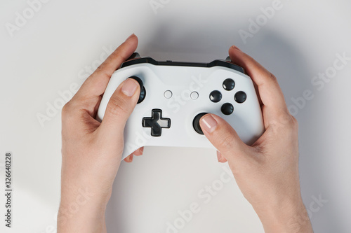 White controller with black buttons in hand