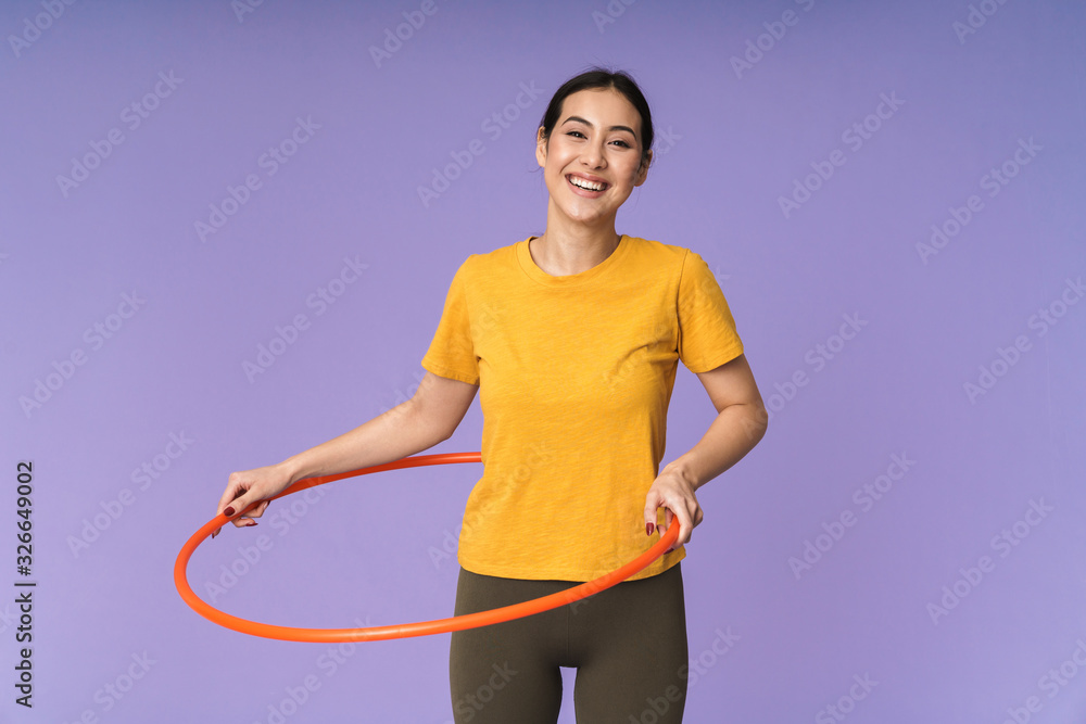 Cheerful young pretty sportswoman standing