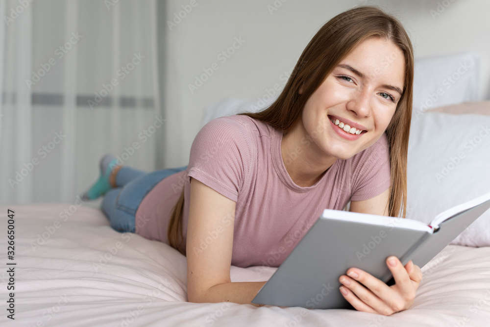 Pretty woman reading a book in bed Pretty woman reading a book in bed