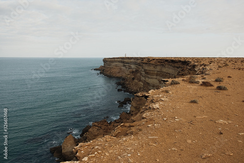 beautiful rugged coastline with waves crashing against the cliffs