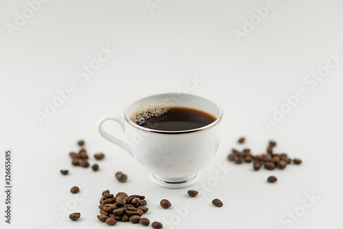 cup of coffee with beans on white background © Kristian