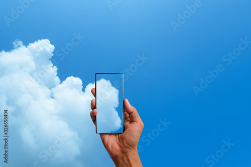 Smart phone  in hand on blue sky background