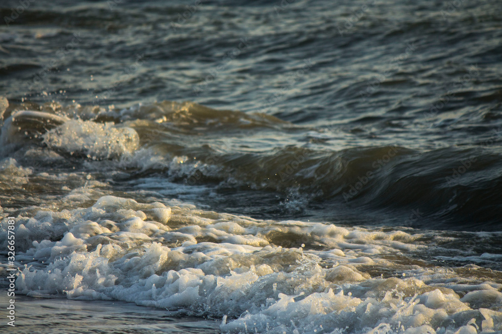 wave on the sand with stones wave on the sand with stones