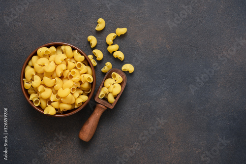 Pasta in a plate on a concrete dark background. Top view copy space.