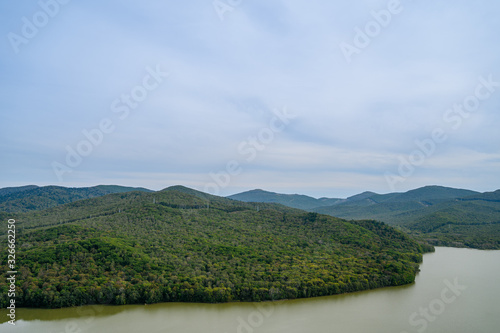 Landscape with green hills and river.