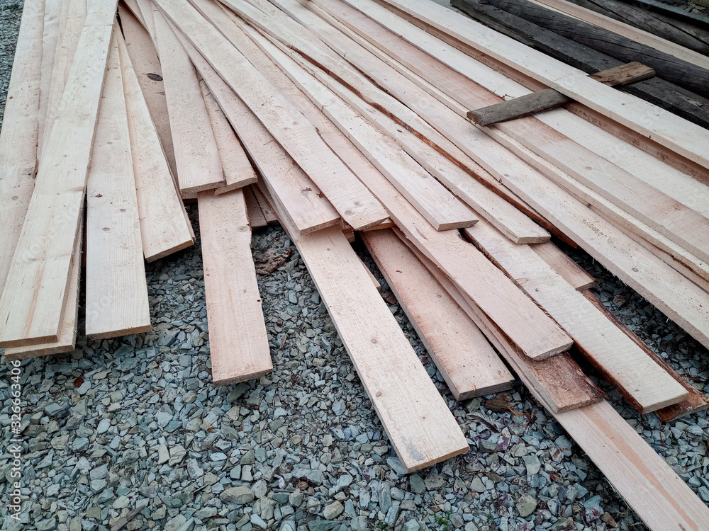 Boards with sawmill. Building material from wood, boards for construction.