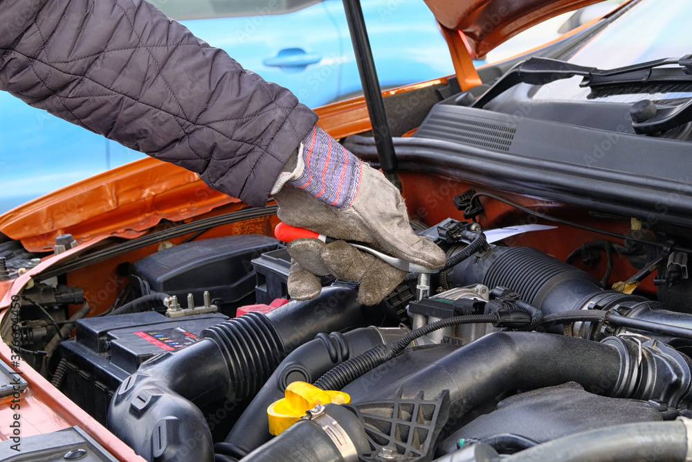 custom made wallpaper toronto digitalCar maintenance and repair concept. Hand of driver in gloves checks car using tools, open hood. Vehicle and transportation, close up.