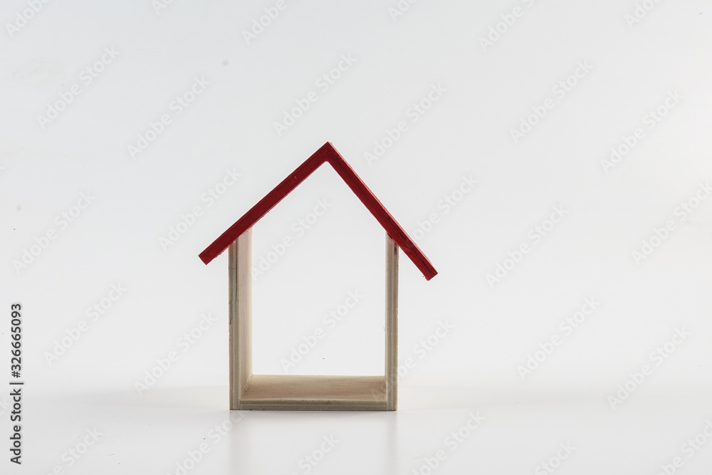 Housing/property concept with small red house isolated on white. Housing/property concept with small red house isolated on white.