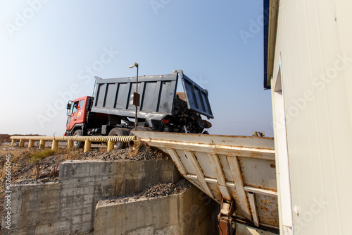 Wallpaper Mural Industrial photography. The dump truck pours natural stone onto the conveyor Torontodigital.ca