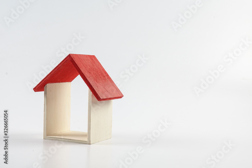 Housing/property concept with small red house isolated on white.
