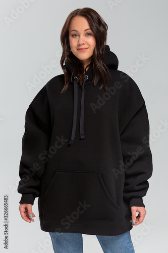Woman in black oversize hoodie, mockup for logo or branding design