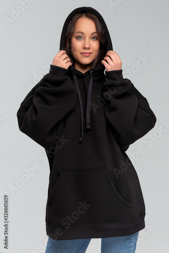 Woman in black oversize hoodie, mockup for logo or branding design