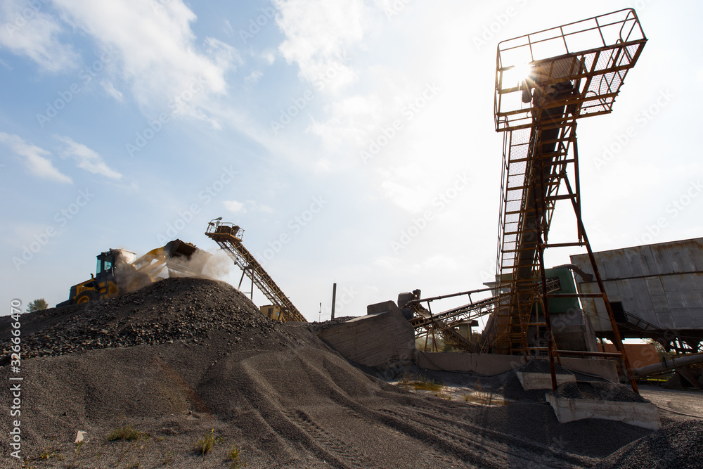 Industrial photography. Crushed stone conveyor for dump trucks in a quarry