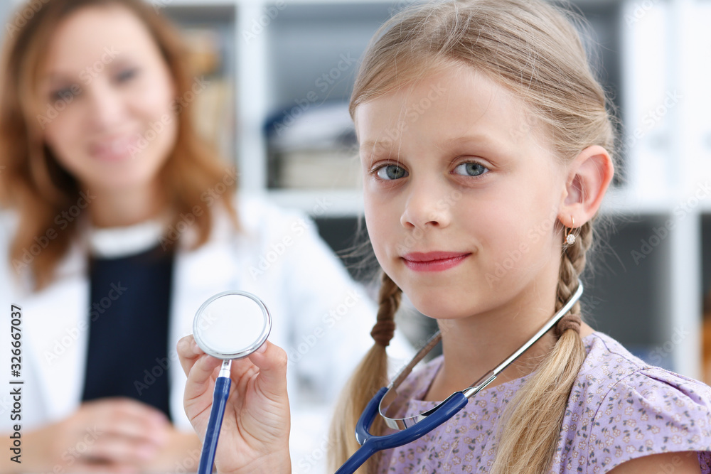 Little child at pediatrician reception. Physical exam appointment, cute infant portrait, baby aid, healthy lifestyle, ward round, child sickness, clinic test, high quality and trust concept Little child at pediatrician reception. Physical exam appointment, cute infant portrait, baby aid, healthy lifestyle, ward round, child sickness, clinic test, high quality and trust concept