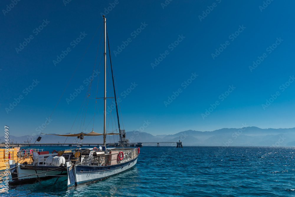  yacht in the sea against the backdrop of mountains