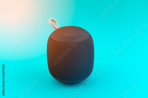 Portable speaker on blue background and flare © Kristian