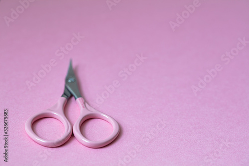 Pink Multi-purpose Stainless Steel manicure scissors on pink background © Ruslan