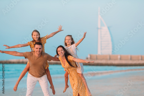 Photography Happy family on the beach during summer vacation