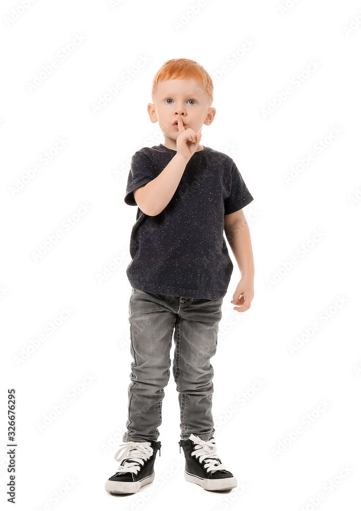 Cute little boy showing silence gesture on white background Cute little boy showing silence gesture on white background