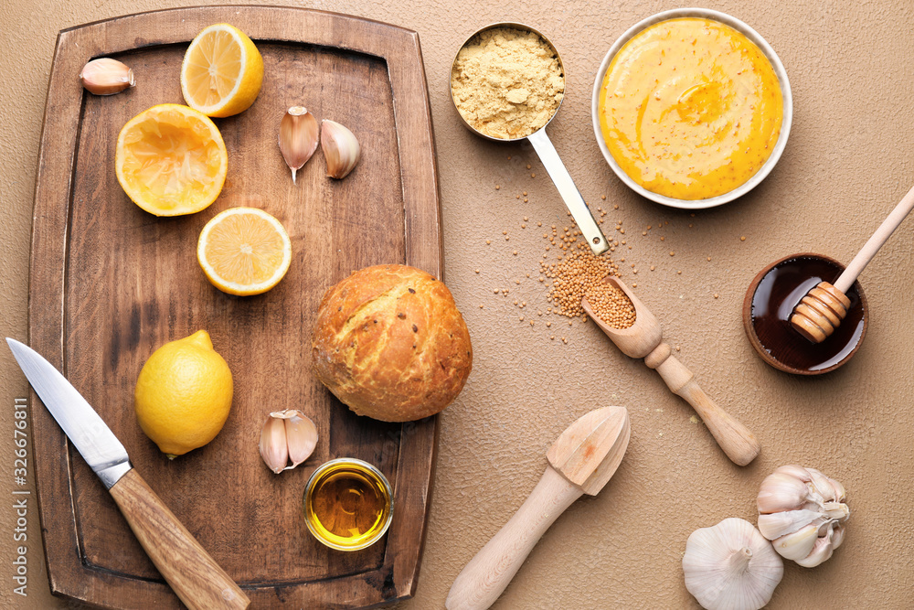 Tasty honey mustard sauce with ingredients on color background Tasty honey mustard sauce with ingredients on color background