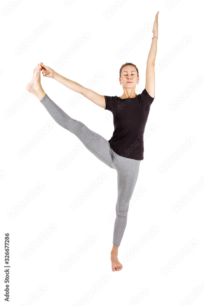 Young woman practicing yoga,standing in an exercise leaning forward to straight legs,eyes closed,holding hands,toes,hasta padangushthasana pose, balance workout,sportswear,pants,short,studio,white Young woman practicing yoga,standing in an exercise leaning forward to straight legs,eyes closed,holding hands,toes,hasta padangushthasana pose, balance workout,sportswear,pants,short,studio,white
