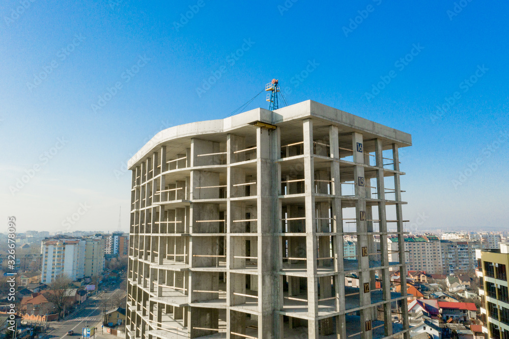 Aerial view of concrete frame of tall apartment building under construction in a city