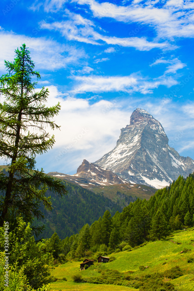 The peak of Matterhorn in Switzerland from the village of Zermatt in the fresh spring. The peak of Matterhorn in Switzerland from the village of Zermatt in the fresh spring.